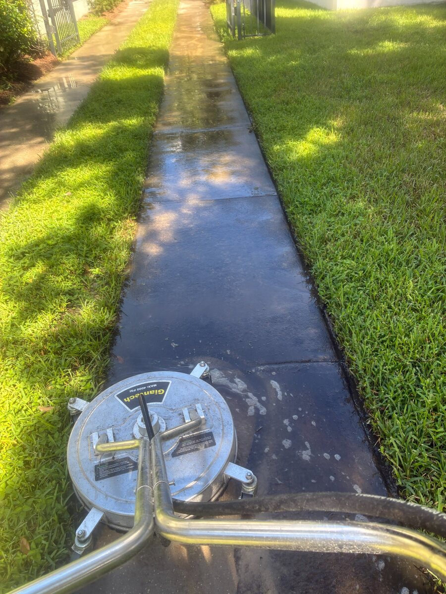 Surface cleaner working on a residential sidewalk in Kissimmee Florida